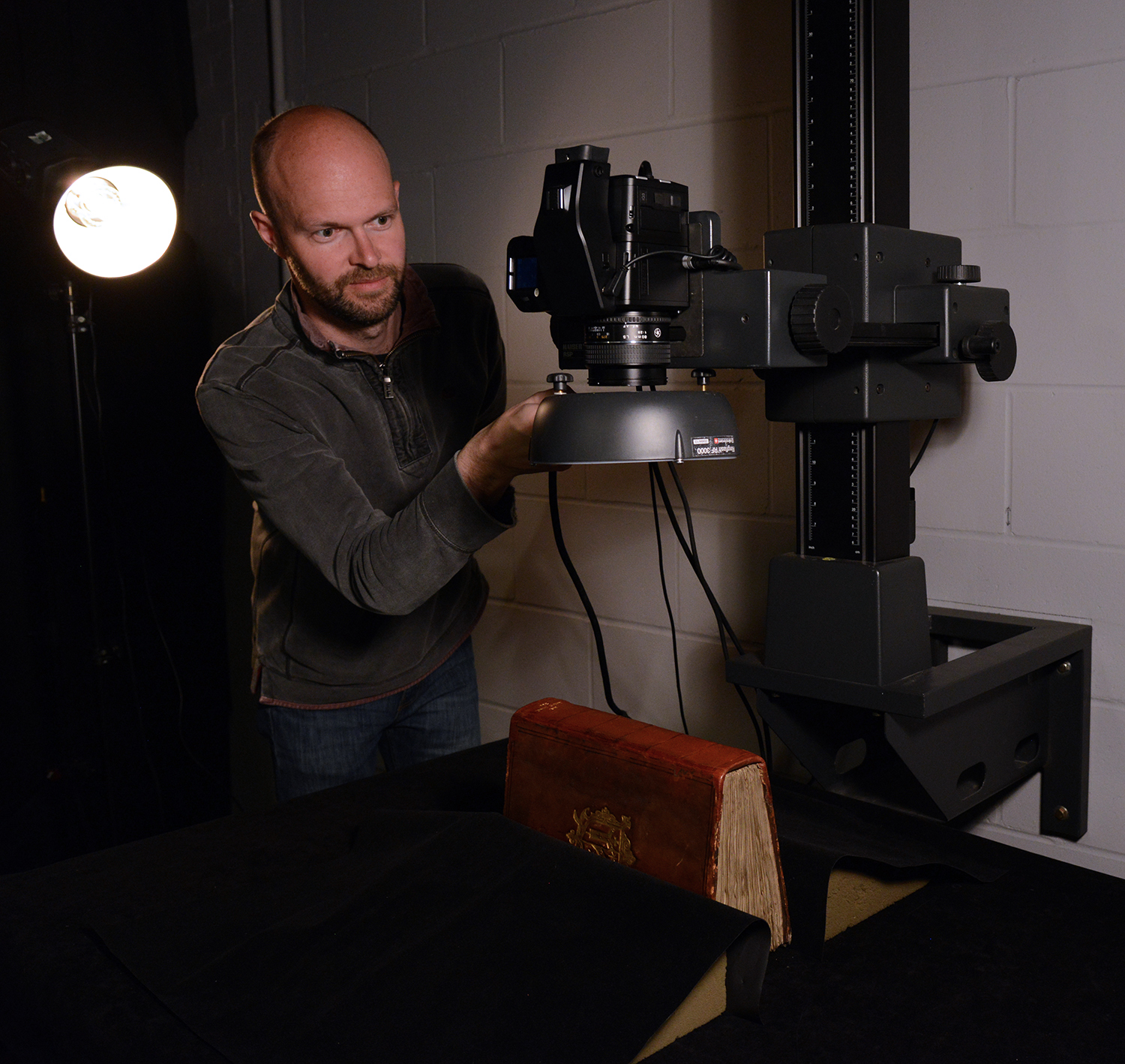 John Barrett capturing the spine of a Laud manuscript